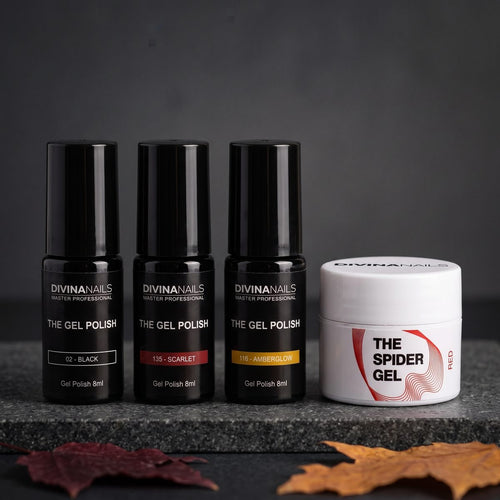 Semipermanenti DIVINA NAILS per Halloween su fondo scuro: il nero 02 BLACK, il rosso 135 Scarlet e l'ambra 116 AMBERGLOW accanto a uno spider gel